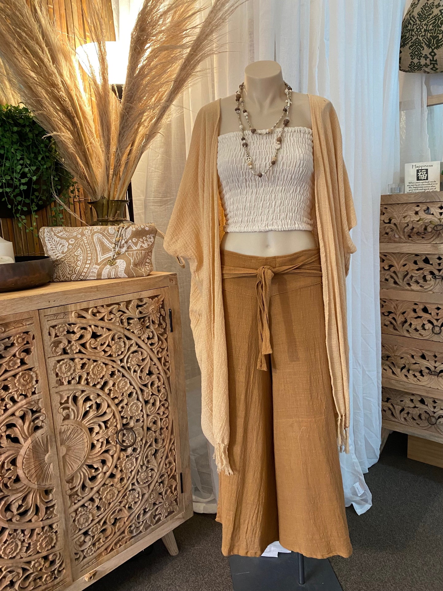 Woman wearing SUKAAH ramie strapless top in natural – women's natural fibre clothing