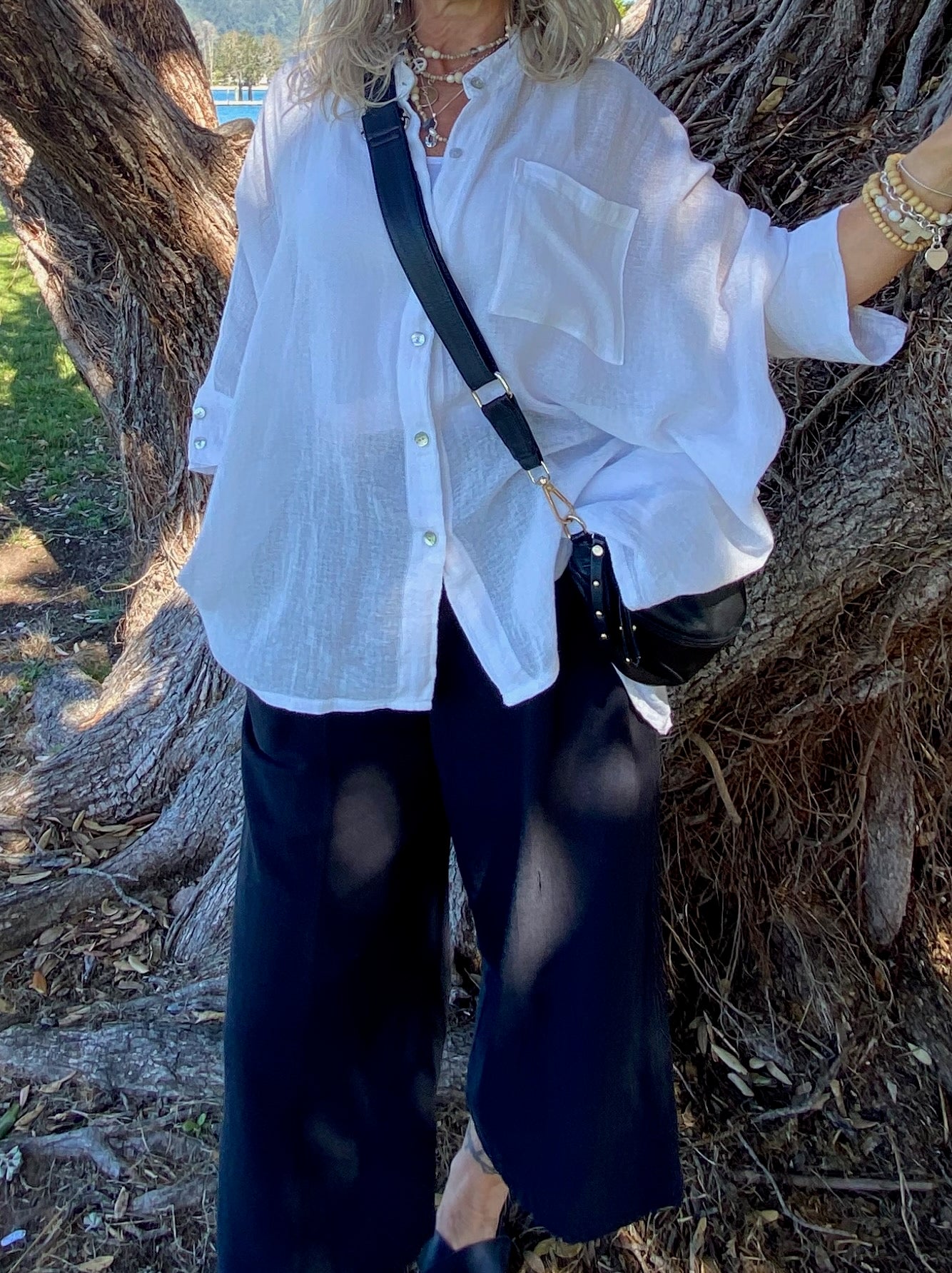 “Model wearing SUKAAH Ramie Isabella bag shirt, relaxed summer resort styling”