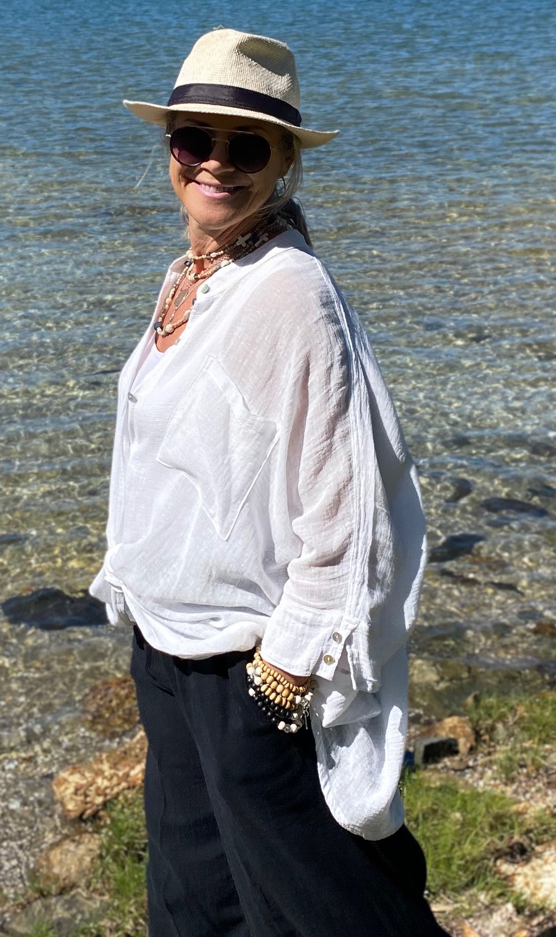 Coastal styling of oversized cotton crush shirt layered over singlet