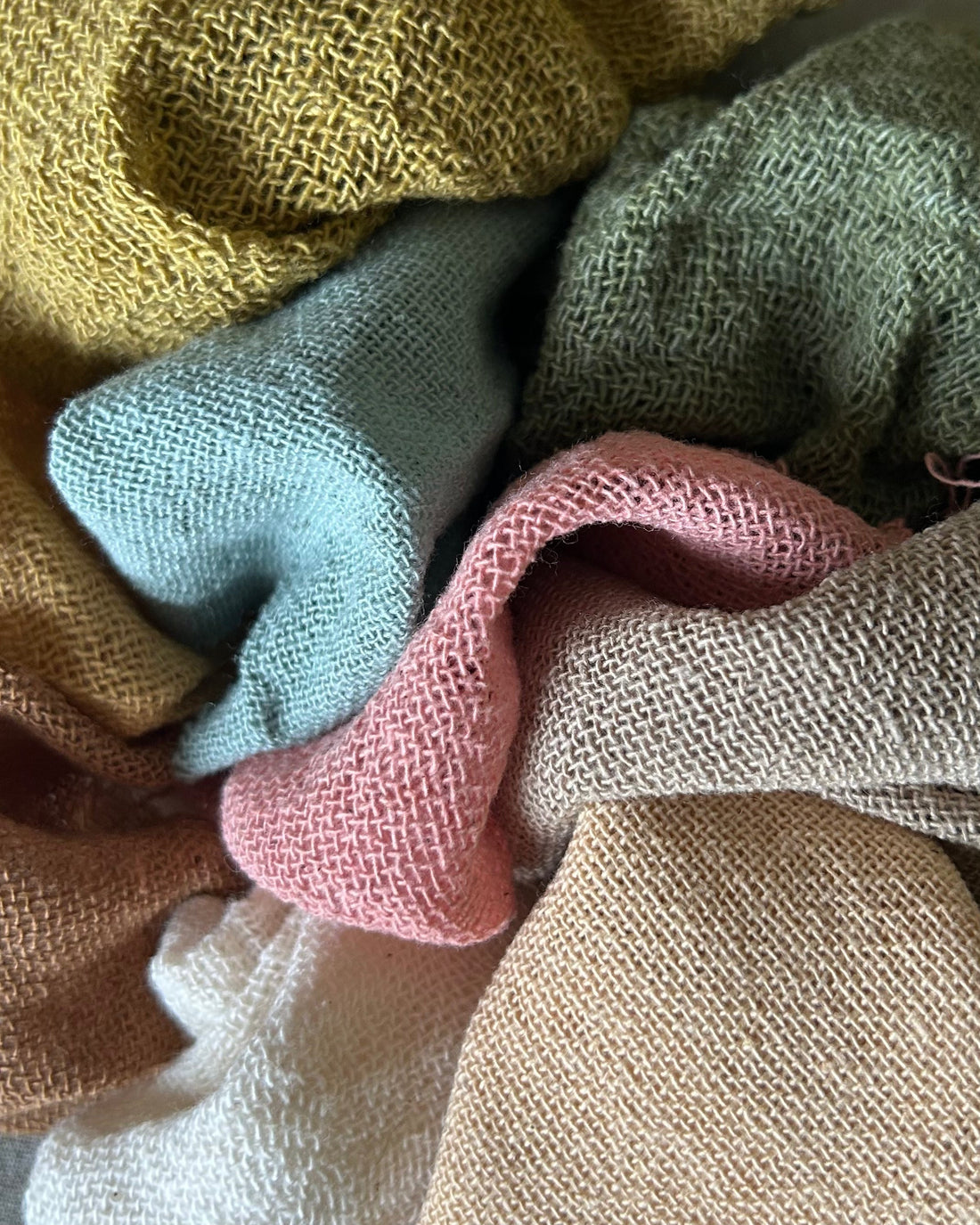 Close-up of ramie fabric swatches in neutral tones, showcasing the natural weave, breathable texture, and lightweight feel of ramie natural fibre used in sustainable clothing.