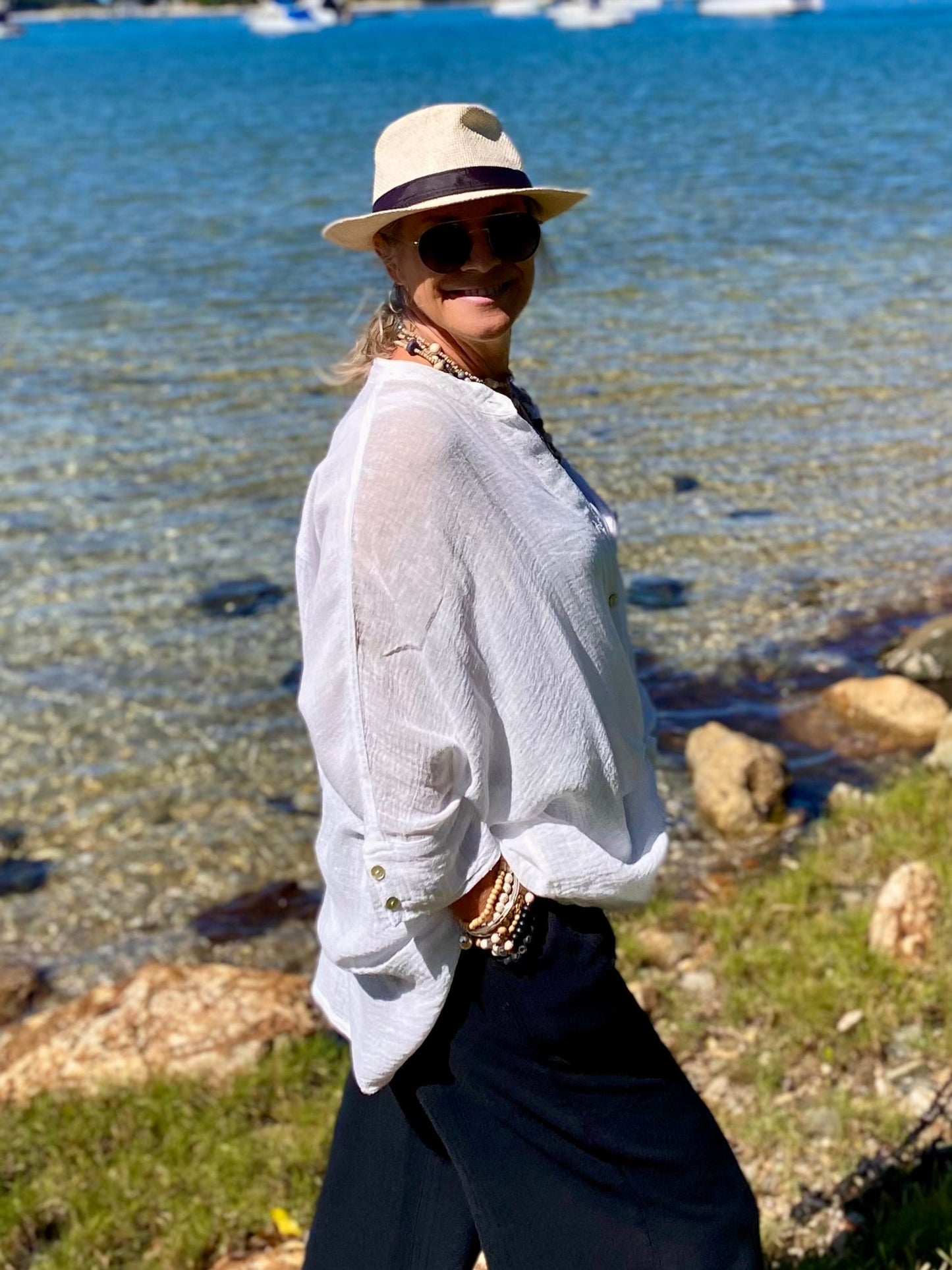 Coastal styling of oversized cotton crush shirt layered over singlet
