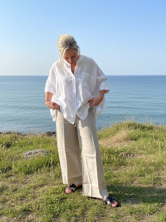 “Model wearing SUKAAH Isabella linen bag shirt styled with long pocket pants, relaxed resort outfit”