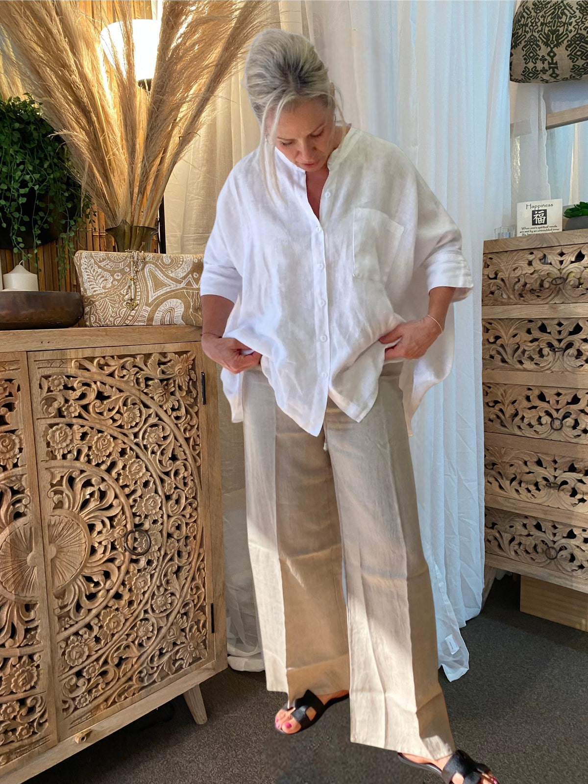 SUKAAH natural linen drawstring pants with wide-leg silhouette styled in warm coastal light