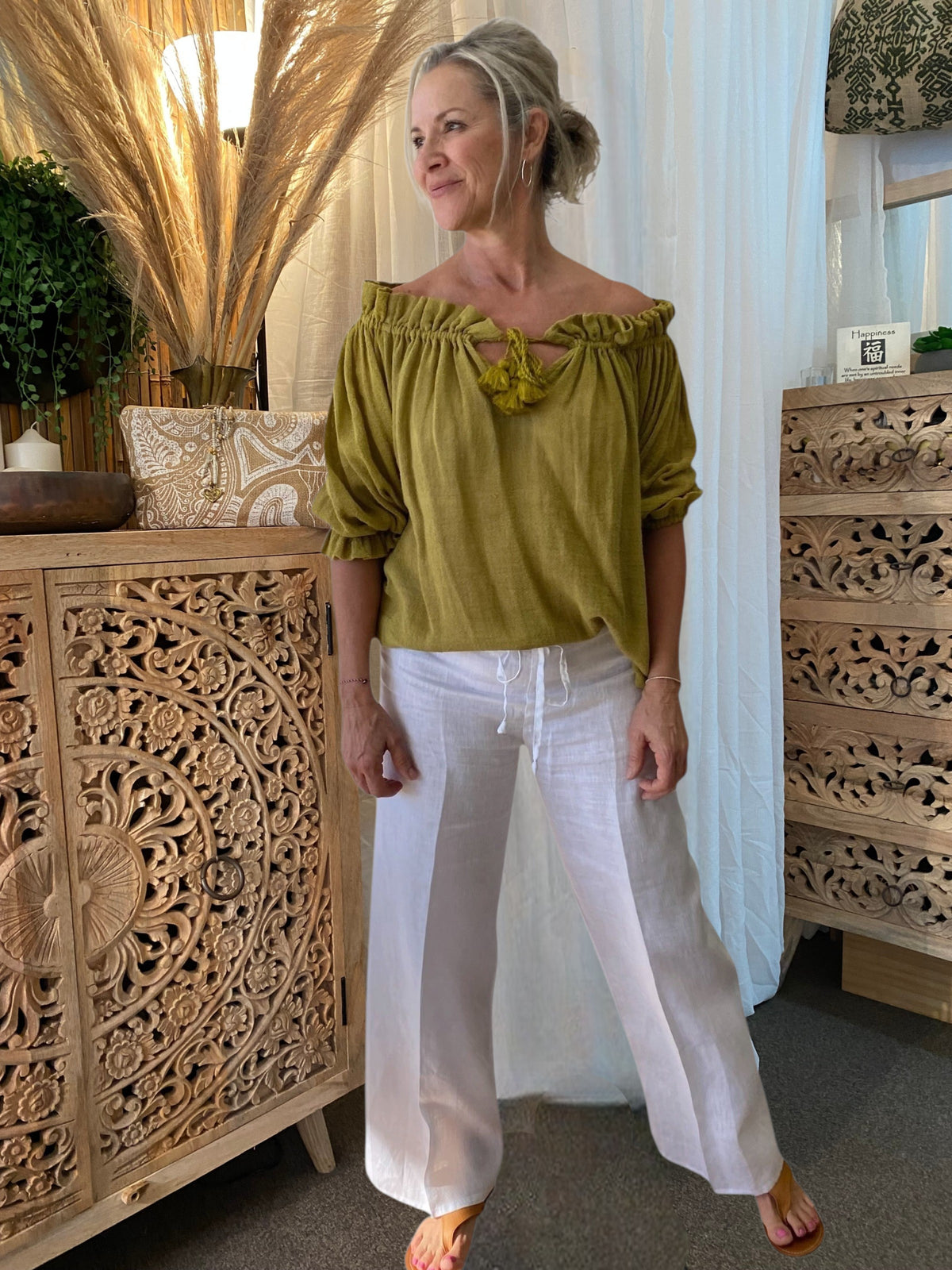 SUKAAH natural linen drawstring pants with wide-leg silhouette styled in warm coastal light